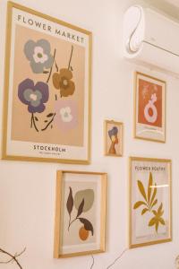 a wall with pictures of flowers on it at Apartament Warmiński Port 50m od jeziora in Olsztyn +44 photos