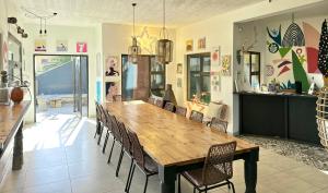 a dining room with a large wooden table and chairs at Skeleton Beach Backpackers in Swakopmund
