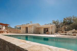 a house with a swimming pool in front of it at Villa Sappho in Magaziá