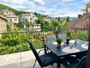 a table and chairs on a balcony with a view at Apartments Villa Ida in Opatija
