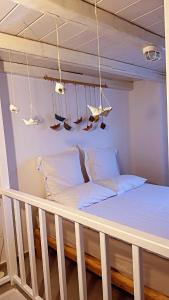 a bed in a room with a swing at Houses of chora in Serifos Chora