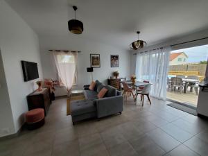 a living room with a couch and a table at Les pivoines Notre-Dame-de-Monts in Notre-Dame-de-Monts