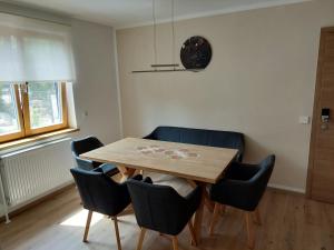 a dining room with a wooden table and chairs at Biohof Meyerhofer in Arbesbach +6 photos