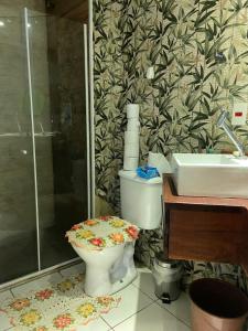 a bathroom with a toilet and a sink at São Francisco Apartment in Taboão da Serra