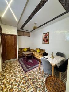 a living room with a couch and a table at Appartement Dar LALA 2 in Fez +13 photos