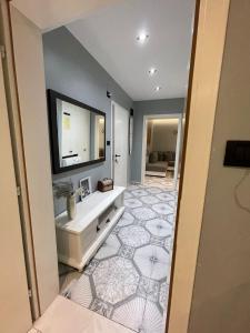 a bathroom with a sink and a mirror at Temali Apartment 1 in Shkodër