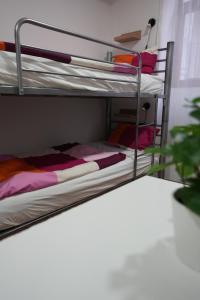 A bed or beds in a room at Center Hostel and Guest House Még 37 kép