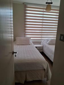 Postel nebo postele na pokoji v ubytování Departamento Av Alemania Mall Portal Temuco + 2 fotografie