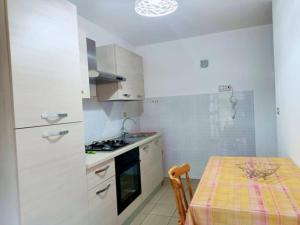 a kitchen with a table and a stove top oven at Tropea CAPO VATICANO villa - Amphitrite in Capo Vaticano +41 photos