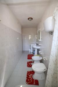 a bathroom with two toilets and a sink at Tropea CAPO VATICANO villa - Amphitrite in Capo Vaticano