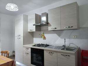 a kitchen with a sink and a stove top oven at Tropea CAPO VATICANO villa - Amphitrite in Capo Vaticano