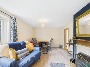 a living room with a blue couch and a table at The Hazels in Staunton