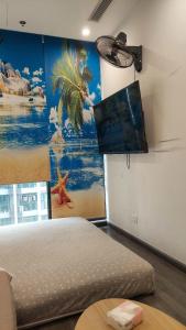 a room with a bed and a painting on the wall at Tonkin2 Luxhomes Smart City in Phú Thú