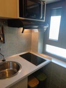 a kitchen with a sink and a microwave at Apartments Marica in Trogir +25 photos