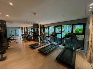 a gym with treadmills and elliptical machines at The base central Pattay CD in Pattaya Central