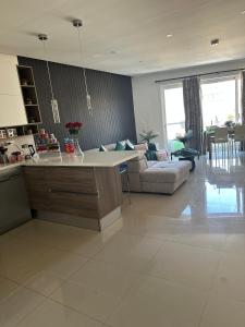 a large kitchen and living room with a couch at Couple's Getaway in Is-Swieqi