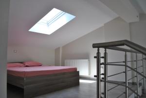 a bedroom with a bed and a skylight at Blue Sea Horizon in Iraklitsa