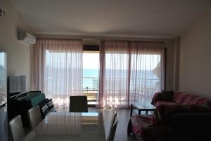 a living room with a large window with a view of the ocean at Blue Sea Horizon in Iraklitsa