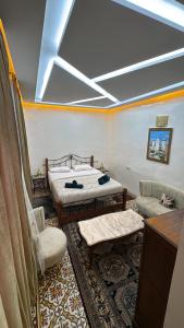 a room with two beds and a couch and a table at Appartement Dar LALA 1 in Fez