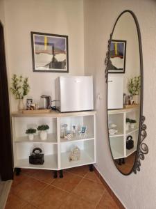 a mirror in a room with white shelves at Rooms Slade in Mali Ston