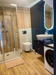 a bathroom with a shower and a toilet and a sink at NICE Apartament Głogów in Głogów +38 photos