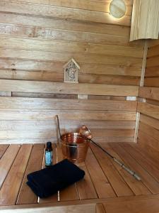 a inside of a sauna with a wooden floor and a bucket at Brīdis Sev in Ķekava +112 photos
