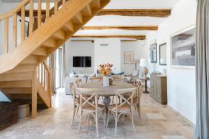 a kitchen and dining room with a wooden table and chairs at Maisons H Normandie in Cricquebœuf +82 photos