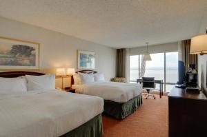 a hotel room with two beds and a television at Vagabond Inn Executive SFO in Burlingame