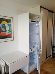 a white refrigerator with its door open in a room at Moniuszki 4 in Cieszyn