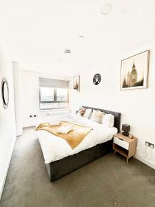 a white bedroom with a large bed and a window at Perfect Stay for Contractors & Families - Sleeps 7 in Bracknell