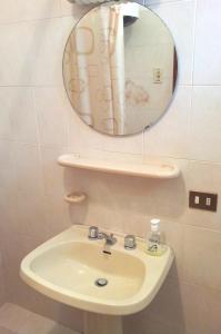 a bathroom with a sink and a mirror at La Terrazza in Barano d'Ischia +5 photos