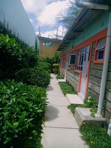a sidewalk in front of a building with a building at Cis Mara Acacia Motel in Narok