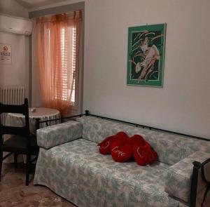 a living room with a couch with a red blanket on it at B&B Ca' dla Marti in Lugo