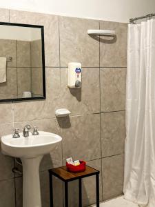 a bathroom with a sink and a shower at CAFAYATE Departamento céntrico in Cafayate +17 photos
