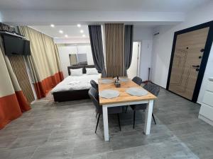 a hotel room with a table and a bed at Sarafovo Relax Night in Burgas City