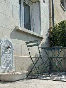 a chair sitting in front of a building at Parenthèse entre forêt et château in Pierrefonds +17 photos