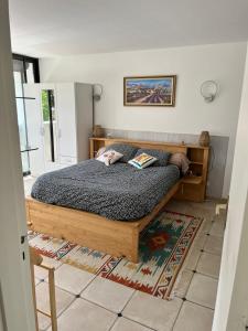 a bedroom with a wooden bed in a room at Le Gryselis in Gréoux-les-Bains