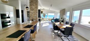 a kitchen and dining room with a view of the ocean at SkyAdria Penthouse in Vir