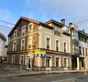 un viejo edificio en la esquina de una calle en Precioso piso 1 muy cerca de la playa de Salinas, en Piedras Blancas