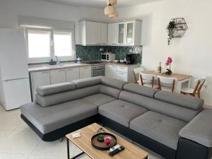 a living room with a couch and a kitchen at marialena villa in Skala Potamias