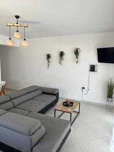 a living room with a couch and a table at marialena villa in Skala Potamias
