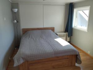a bed in a bedroom with a window at Sveciu namai in Sandeid