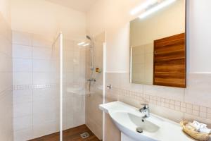 a bathroom with a sink and a shower at B&B Lajta Park in Mosonmagyaróvár