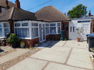 a house with white windows and a driveway at The Homestay Get Away in Kent
