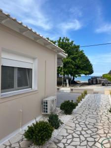 a house with a window and a stone driveway at marialena villa in Skala Potamias