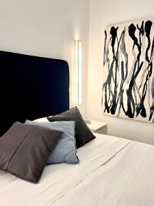 a bed with two pillows and a painting on the wall at Sorrento Garden in Sorrento +41 photos