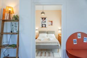 a small bedroom with a bed and a ladder at Arodou Studio and Apartment in Mikonos