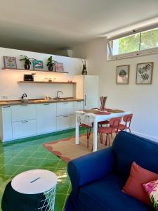 a kitchen with a blue couch and a table at Sorrento Garden in Sorrento