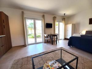 a living room with a bed and a table at 2-Person Studio, Private Splash Pool, 5 Min Beach in Novo Sancti Petri