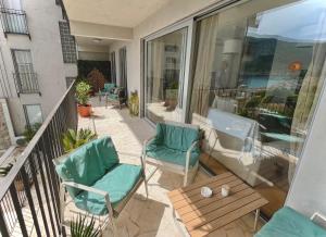 a balcony with two chairs and a table at The Legendary Apartment in Dobrota
